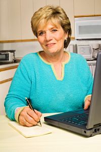 mature-woman-working-at-home-in-kitchen