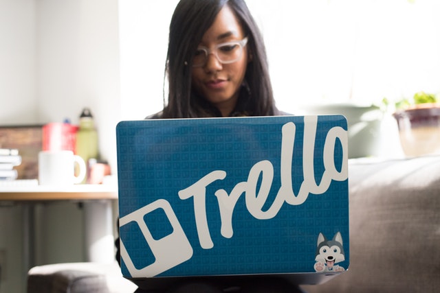 woman wearing eyeglasses using blue and and gray laptop 1181494